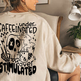 a woman sitting in a chair wearing a sweatshirt