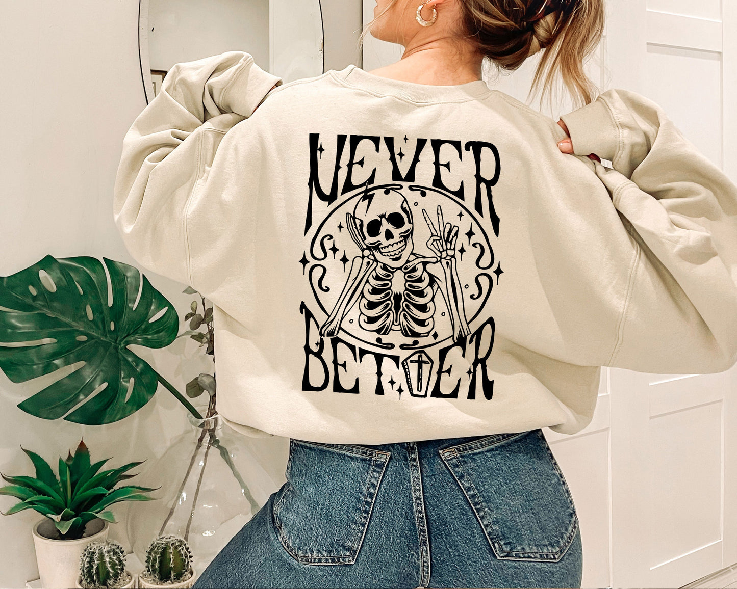 a woman wearing a sweatshirt with a skeleton on it