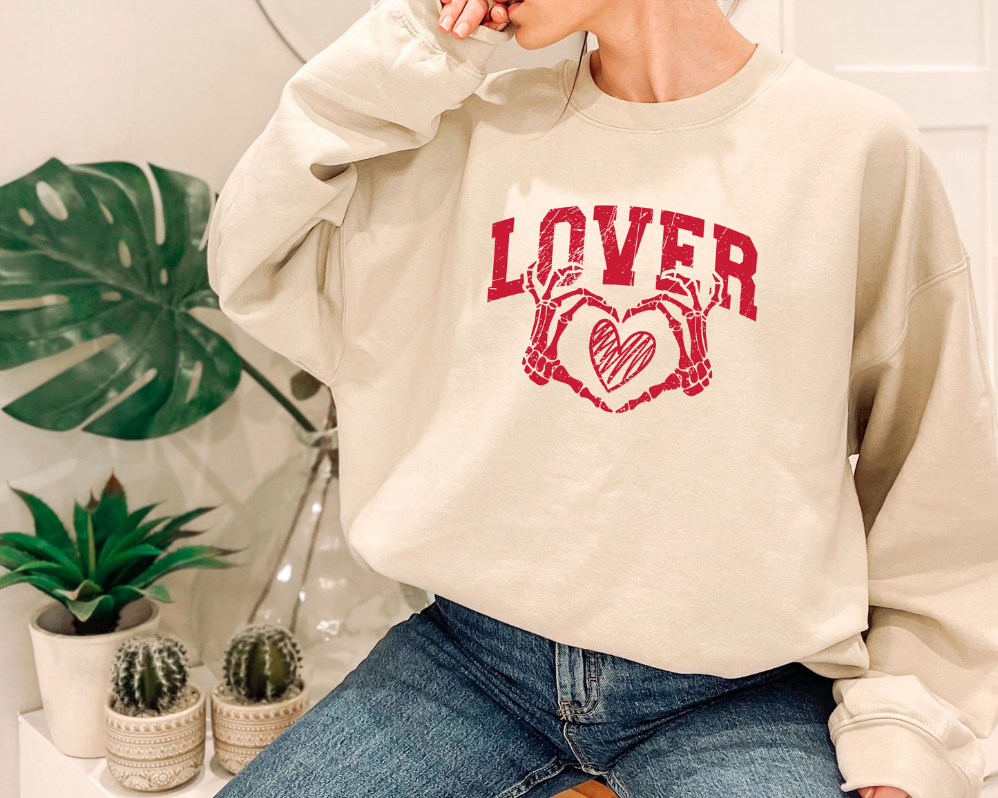 a woman wearing a sweatshirt with the word lover on it