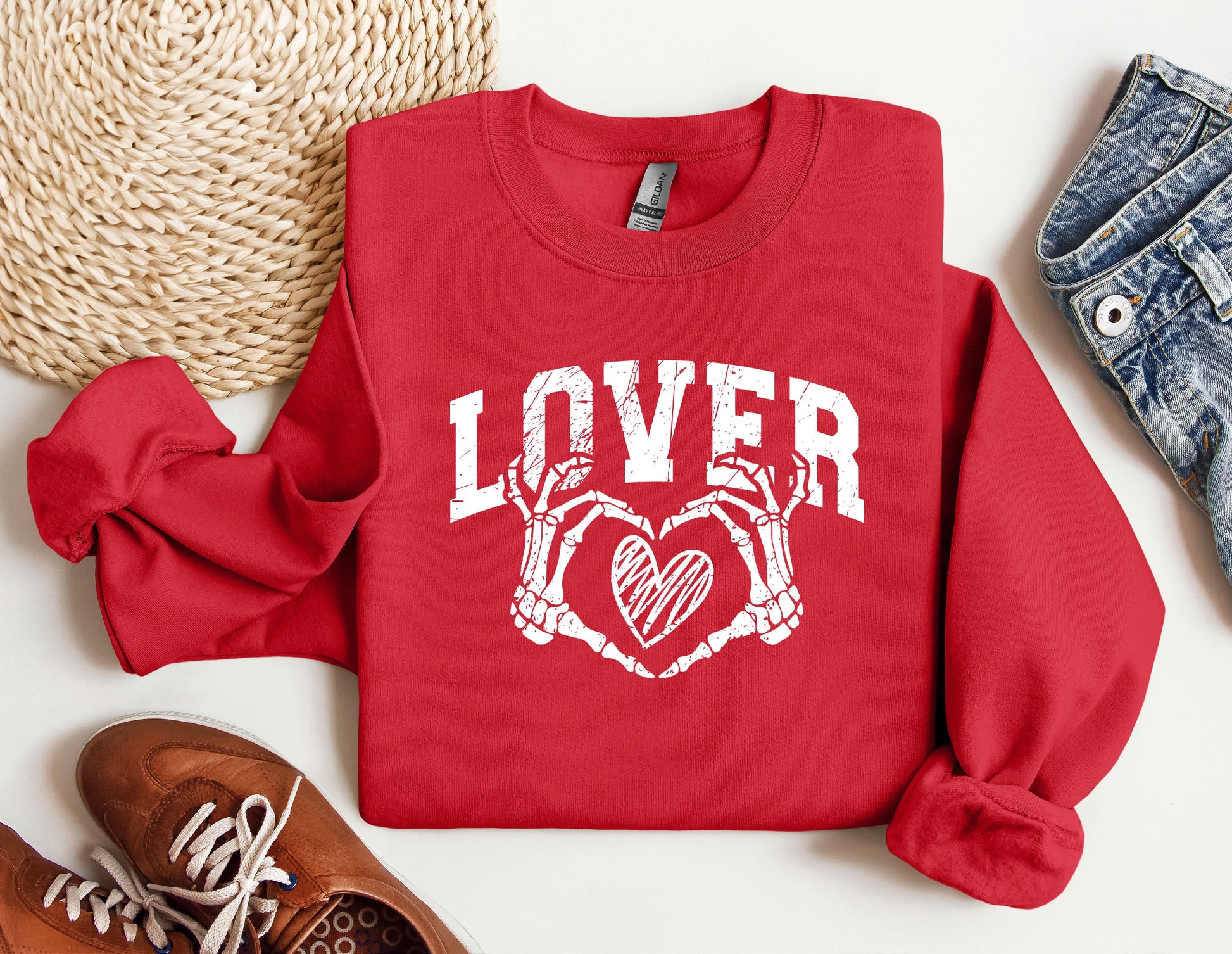 a red sweatshirt with a heart and two crossed arms