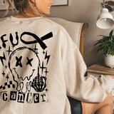 a woman sitting in a chair wearing a sweatshirt with a skull on it