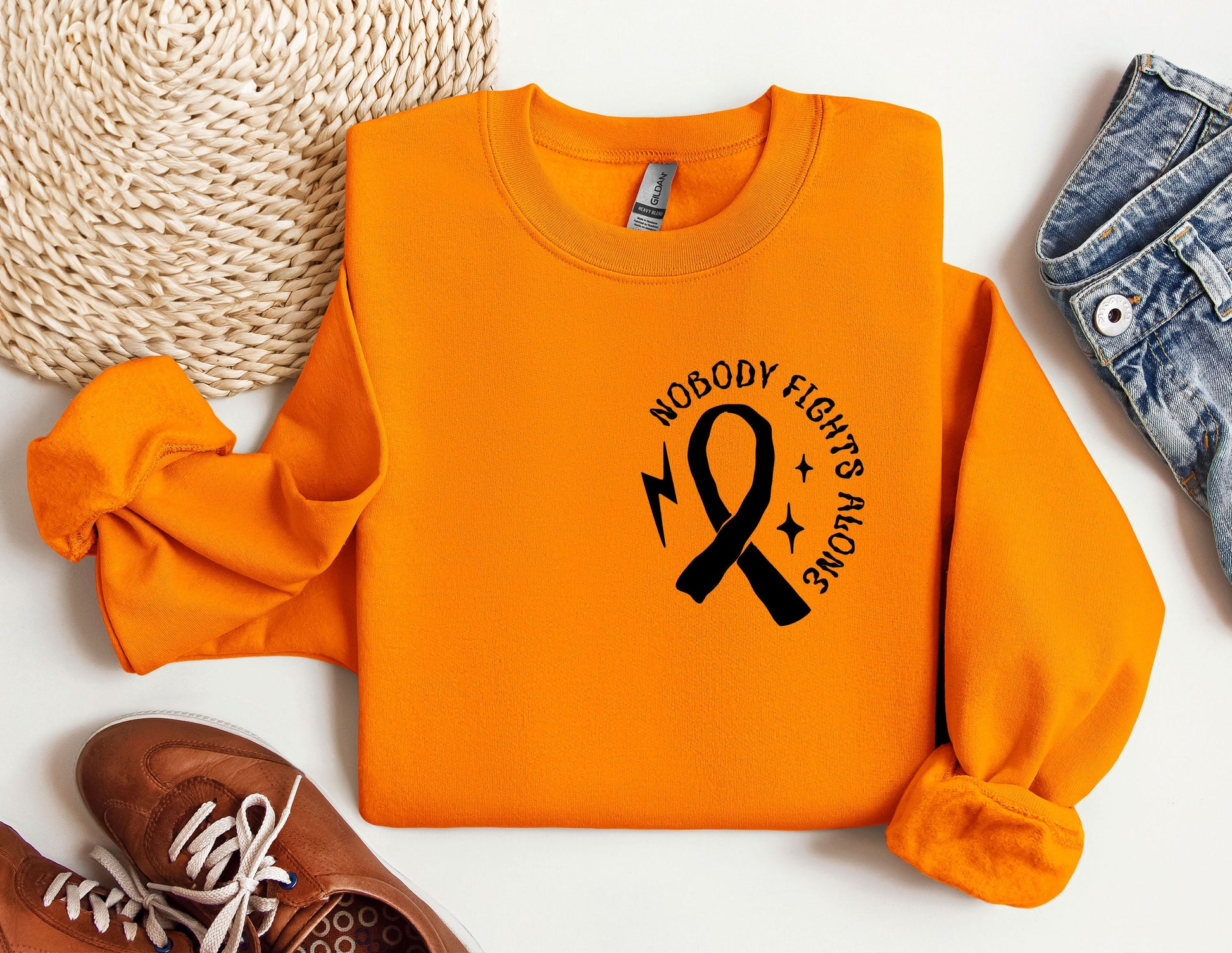 an orange shirt with a ribbon and a pair of shoes