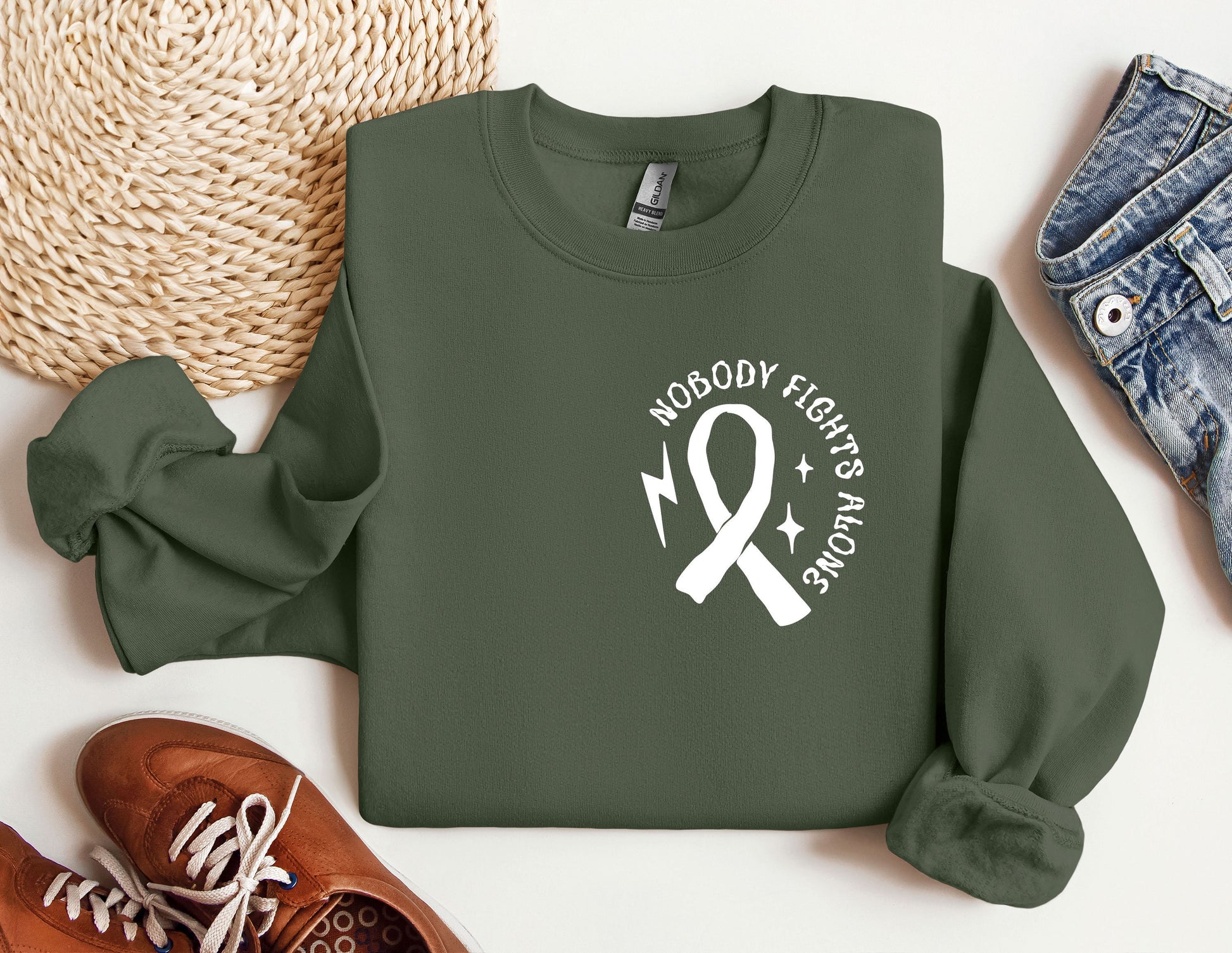 a green sweatshirt with a white ribbon and a pair of shoes