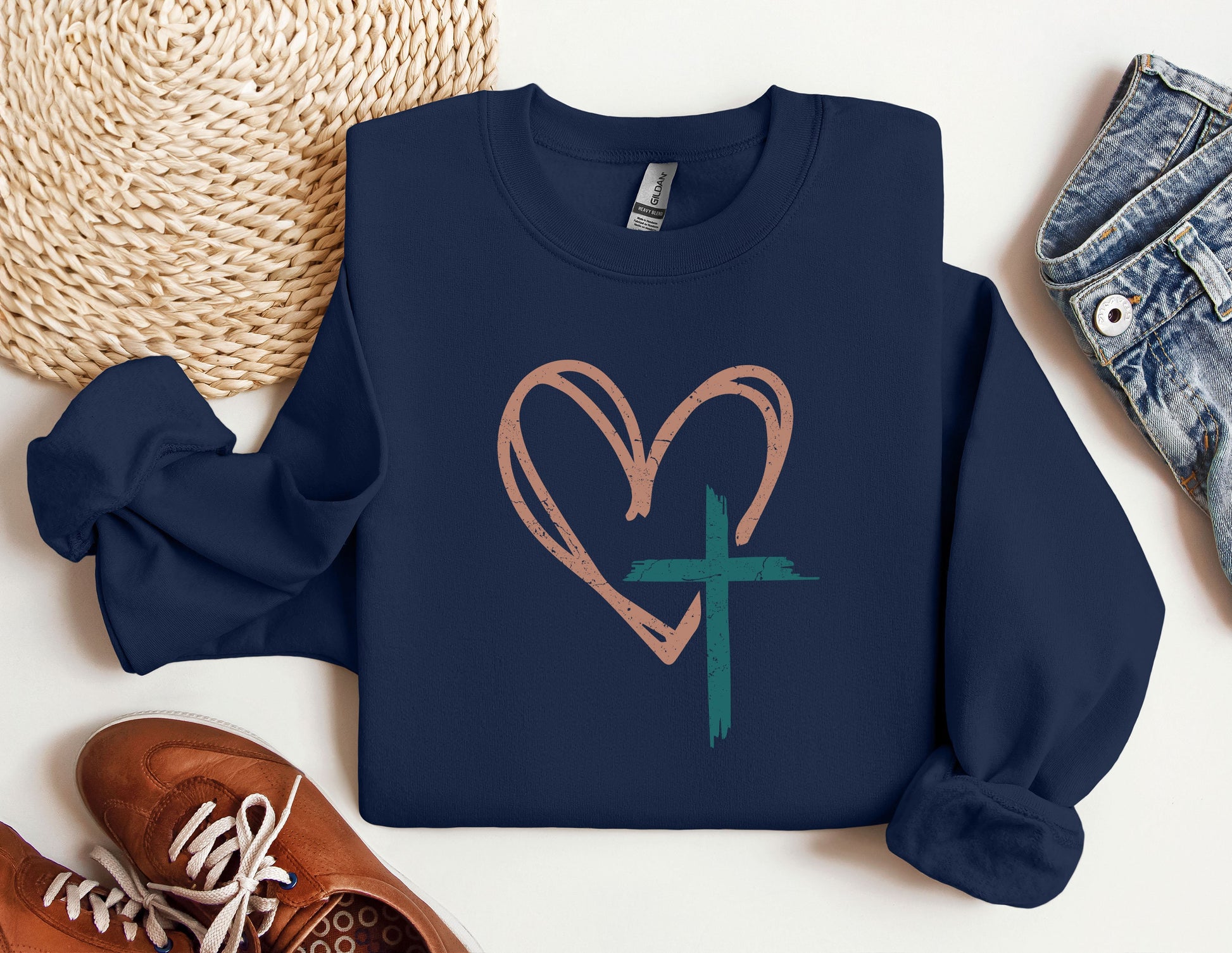 a blue sweatshirt with a heart and a cross on it