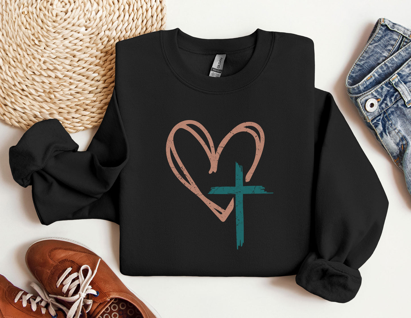 a black sweatshirt with a heart and a cross on it