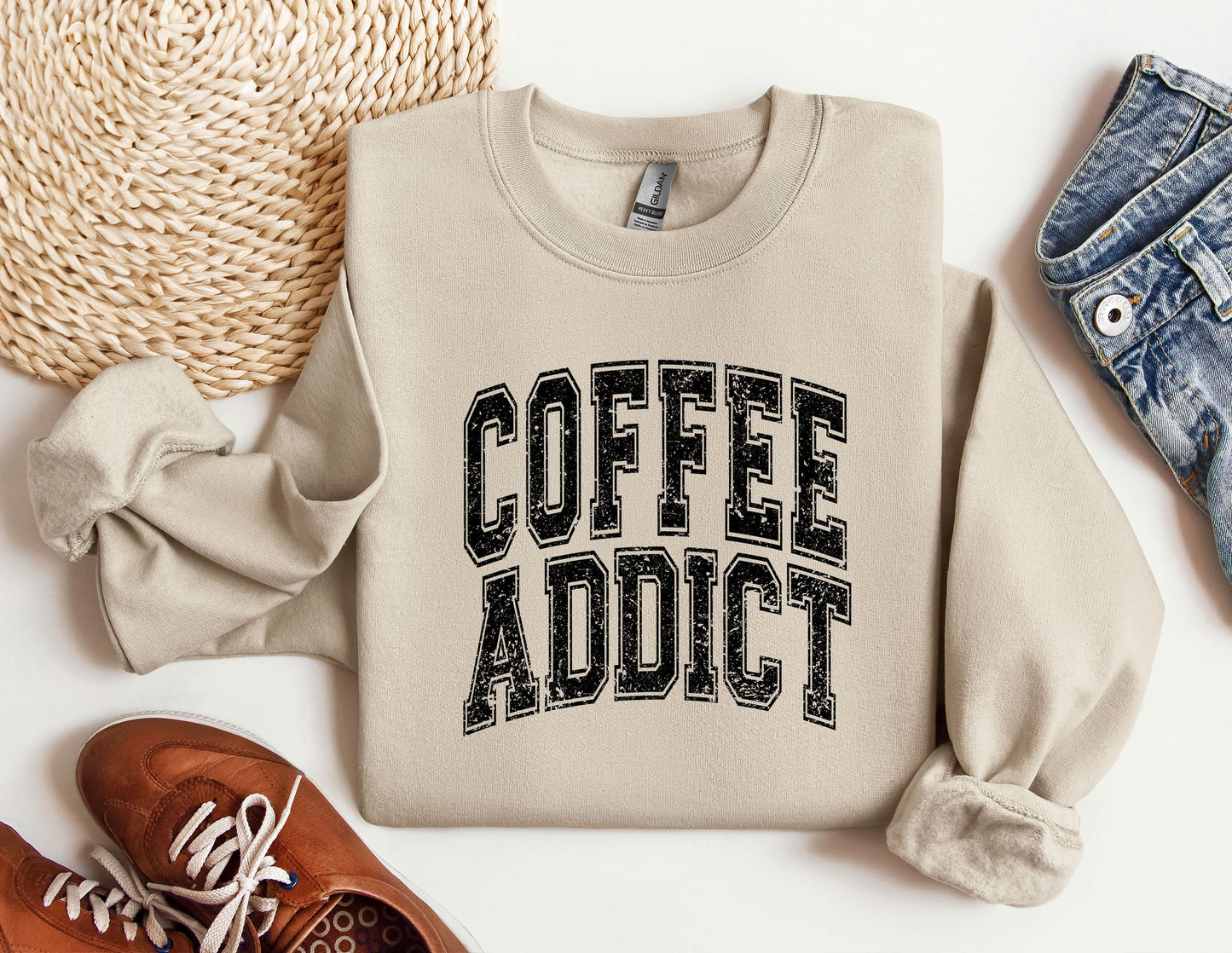 a sweater that says coffee addict next to a pair of shoes