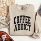 a sweater that says coffee addict next to a pair of shoes