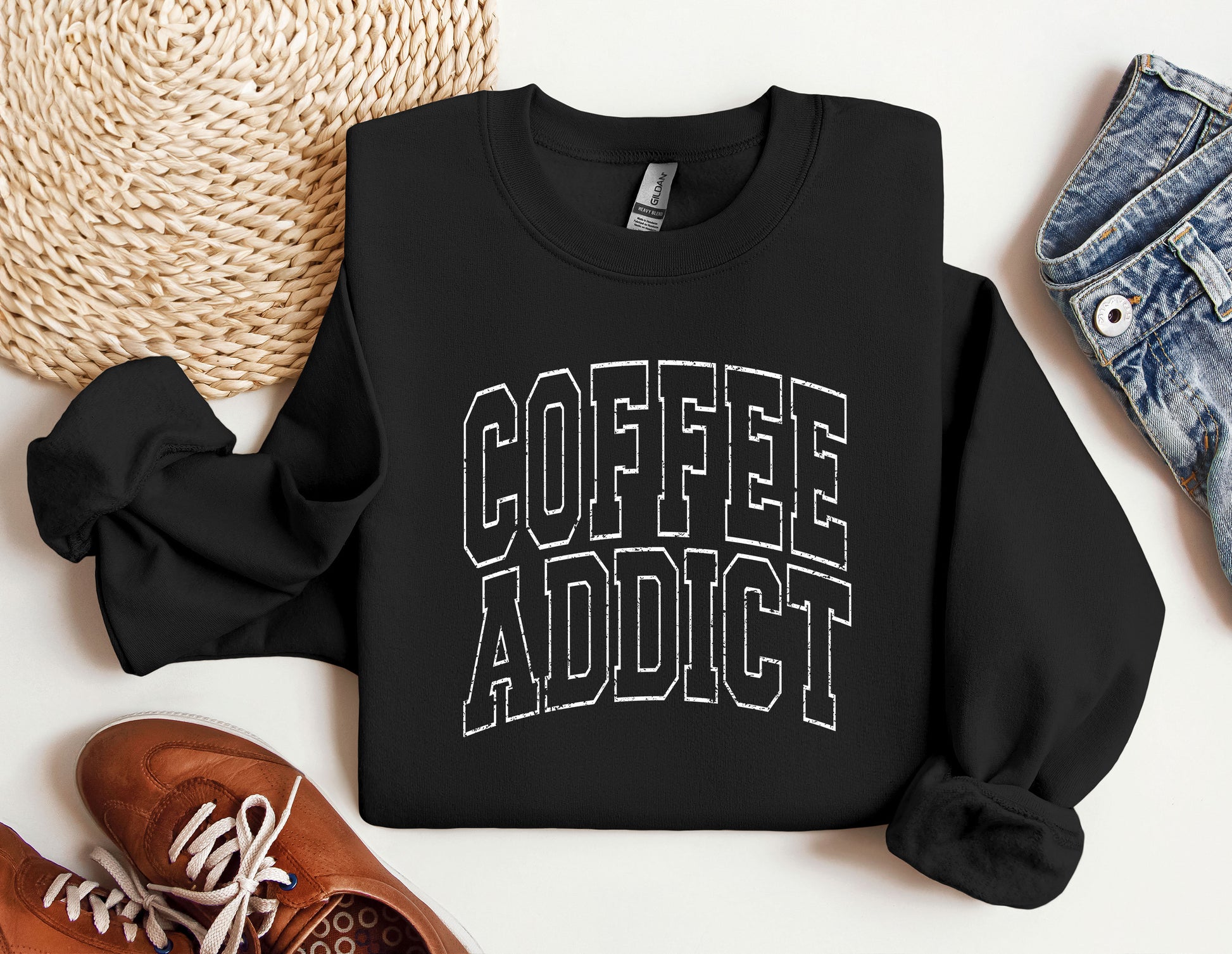 a sweatshirt that says coffee addict next to a pair of sneakers