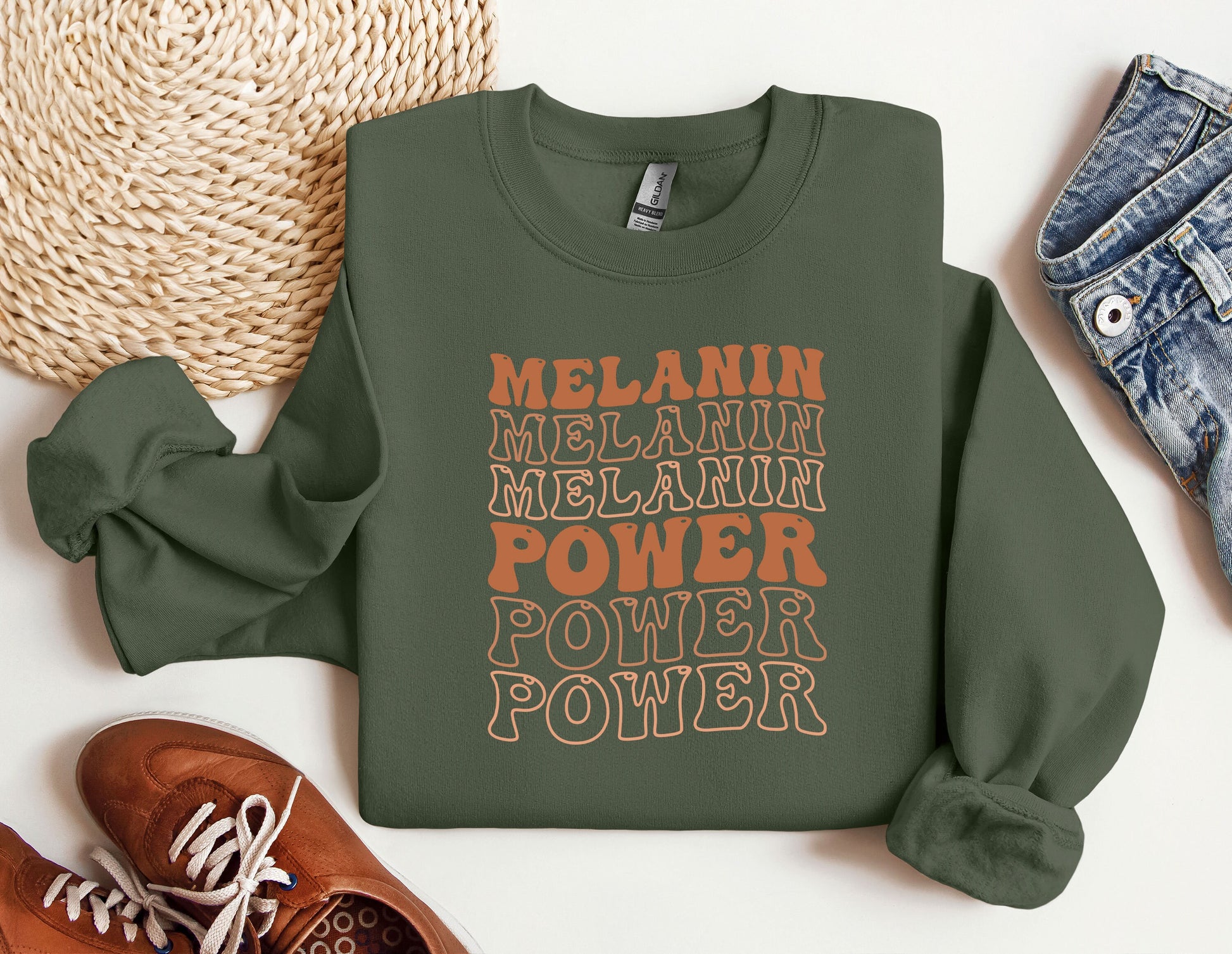 a green sweatshirt with the words melanin, melanin, melani
