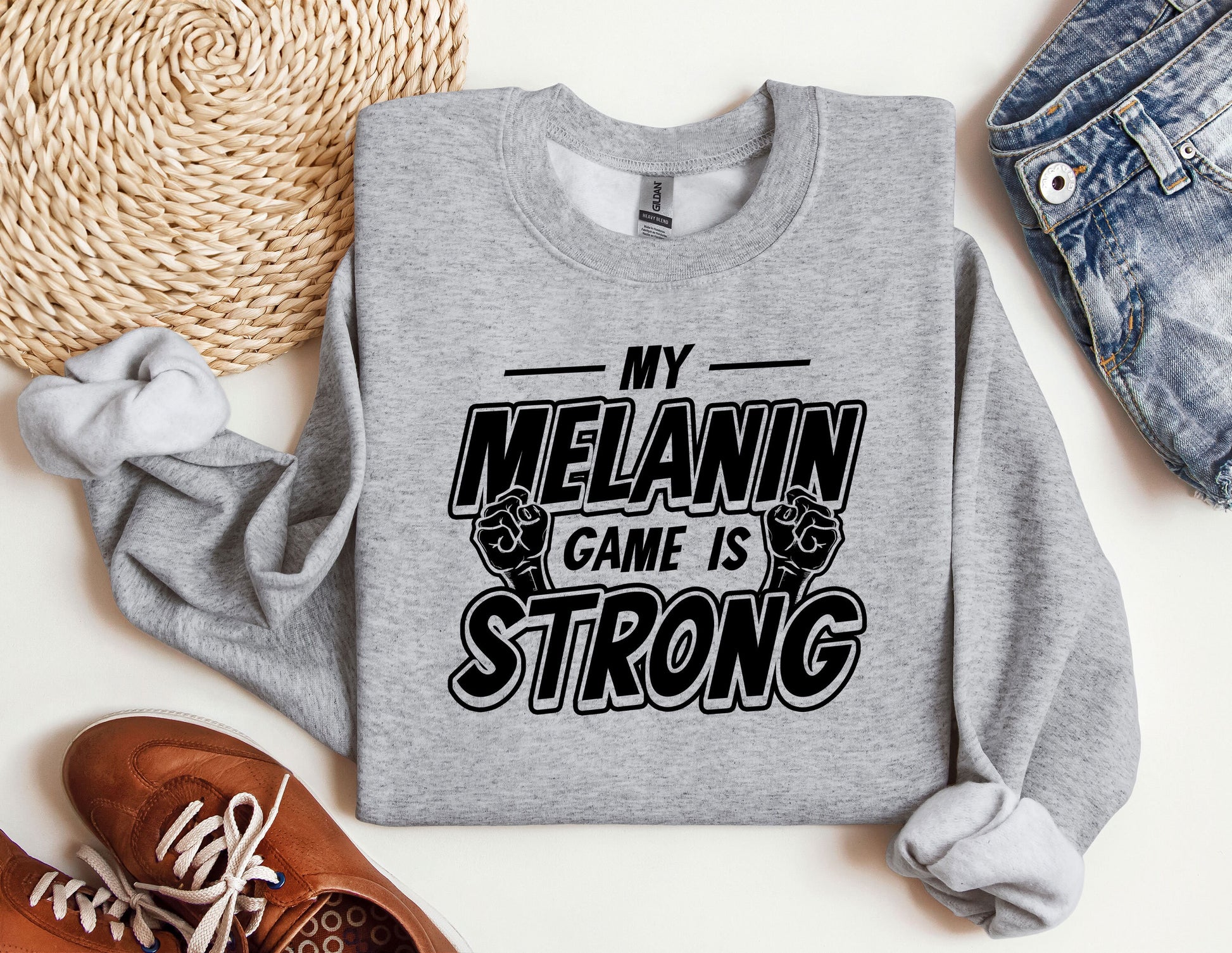 a sweatshirt that says, my melanin game is strong