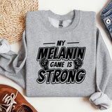 a sweatshirt that says, my melanin game is strong