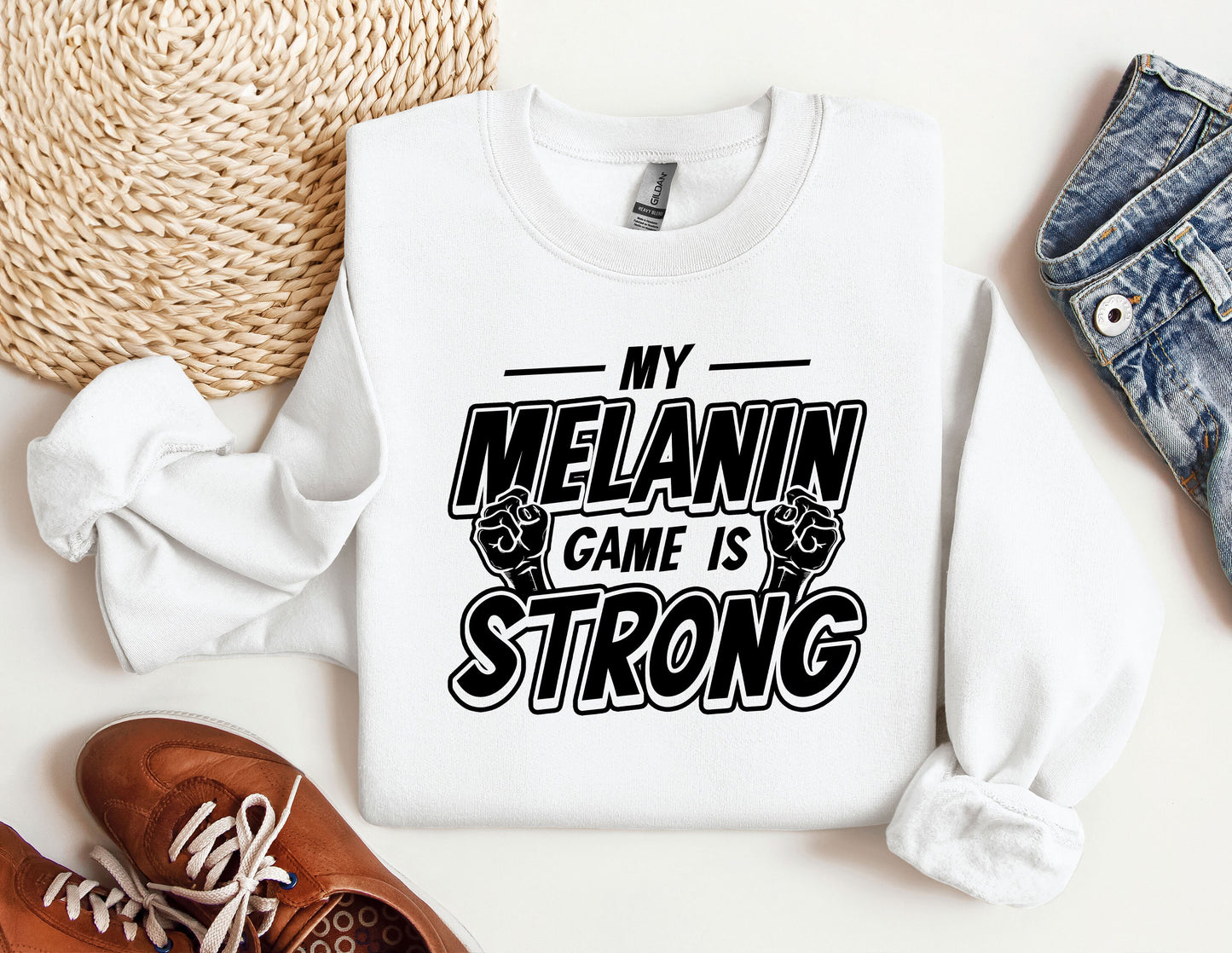 a white sweatshirt that says my melanin came is strong