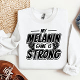 a white sweatshirt that says my melanin came is strong
