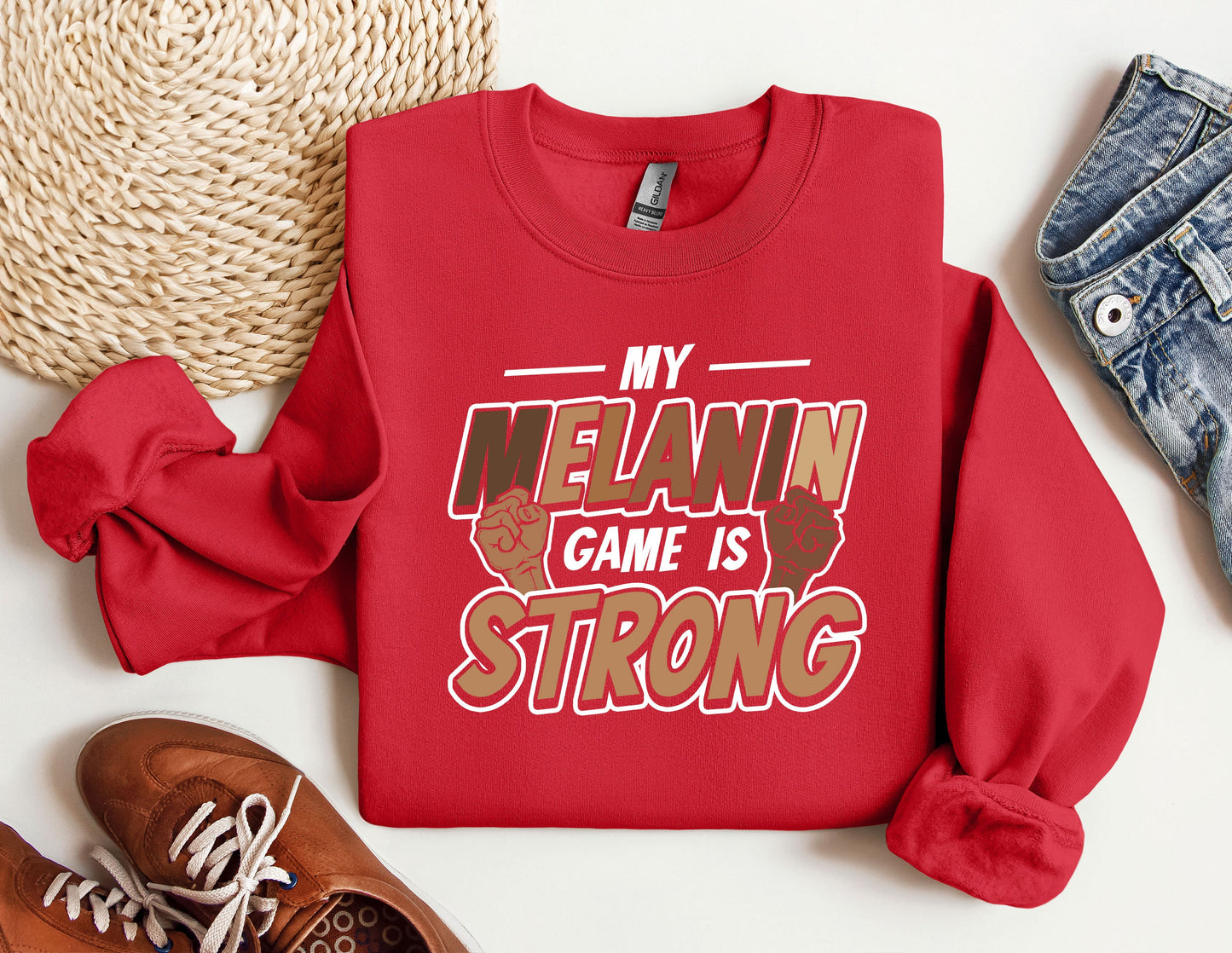 a red sweatshirt that says, my melanin game is strong