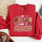 a red sweatshirt that says, my melanin game is strong