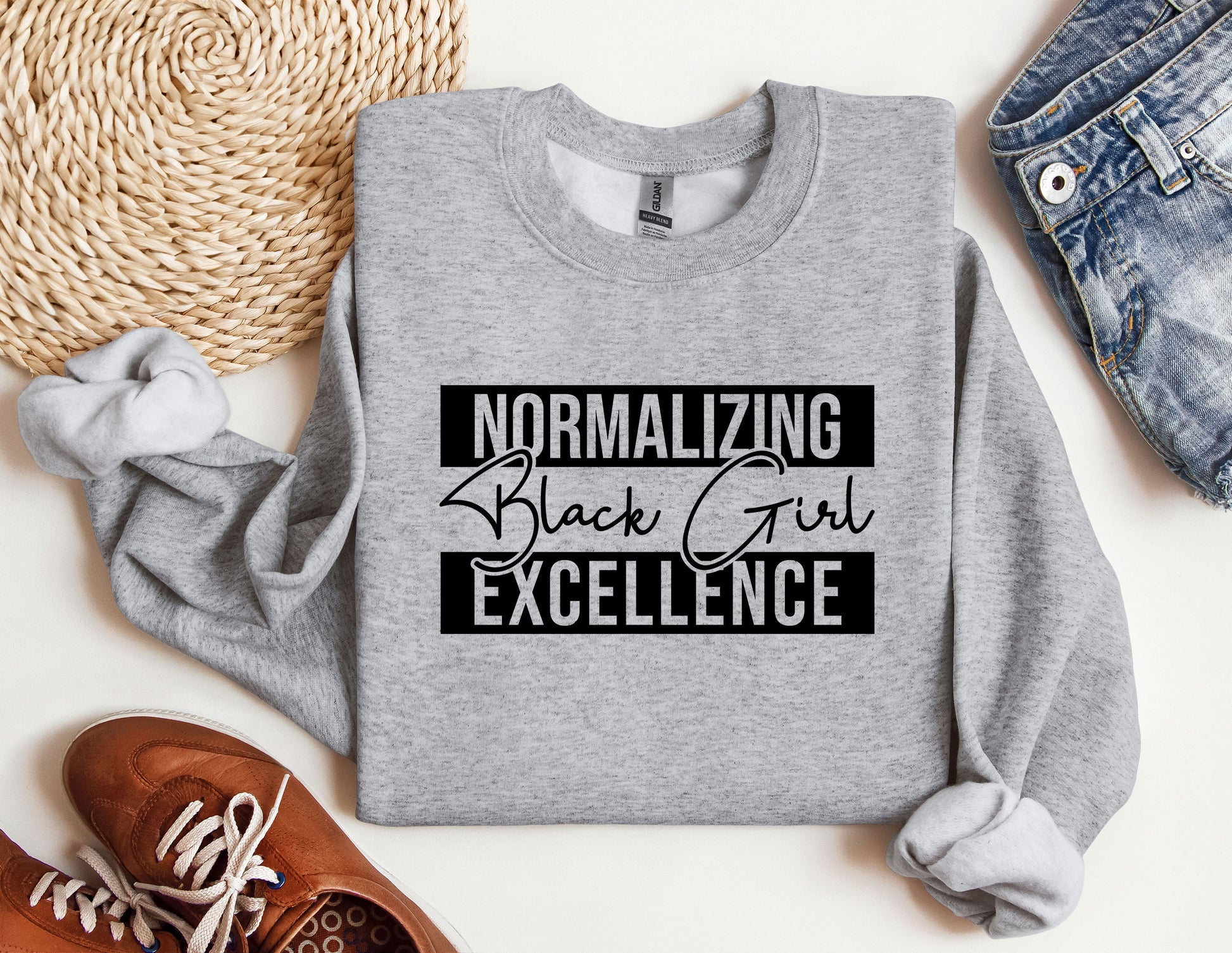 a sweatshirt with the words normalizing black girl excellence on it