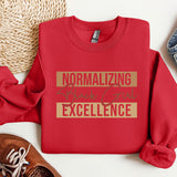 a red sweatshirt with the words normalizing excellence on it