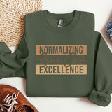 a green sweatshirt with the words normalizing black girl excellence on it