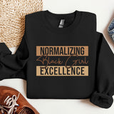 a black shirt that says normalizing black girl excellence