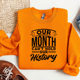 an orange shirt that says our month can't hold our history