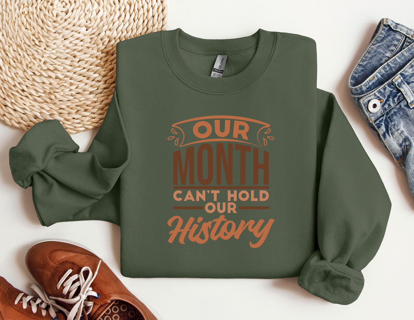 a green sweatshirt that says our month can&#39;t hold our history