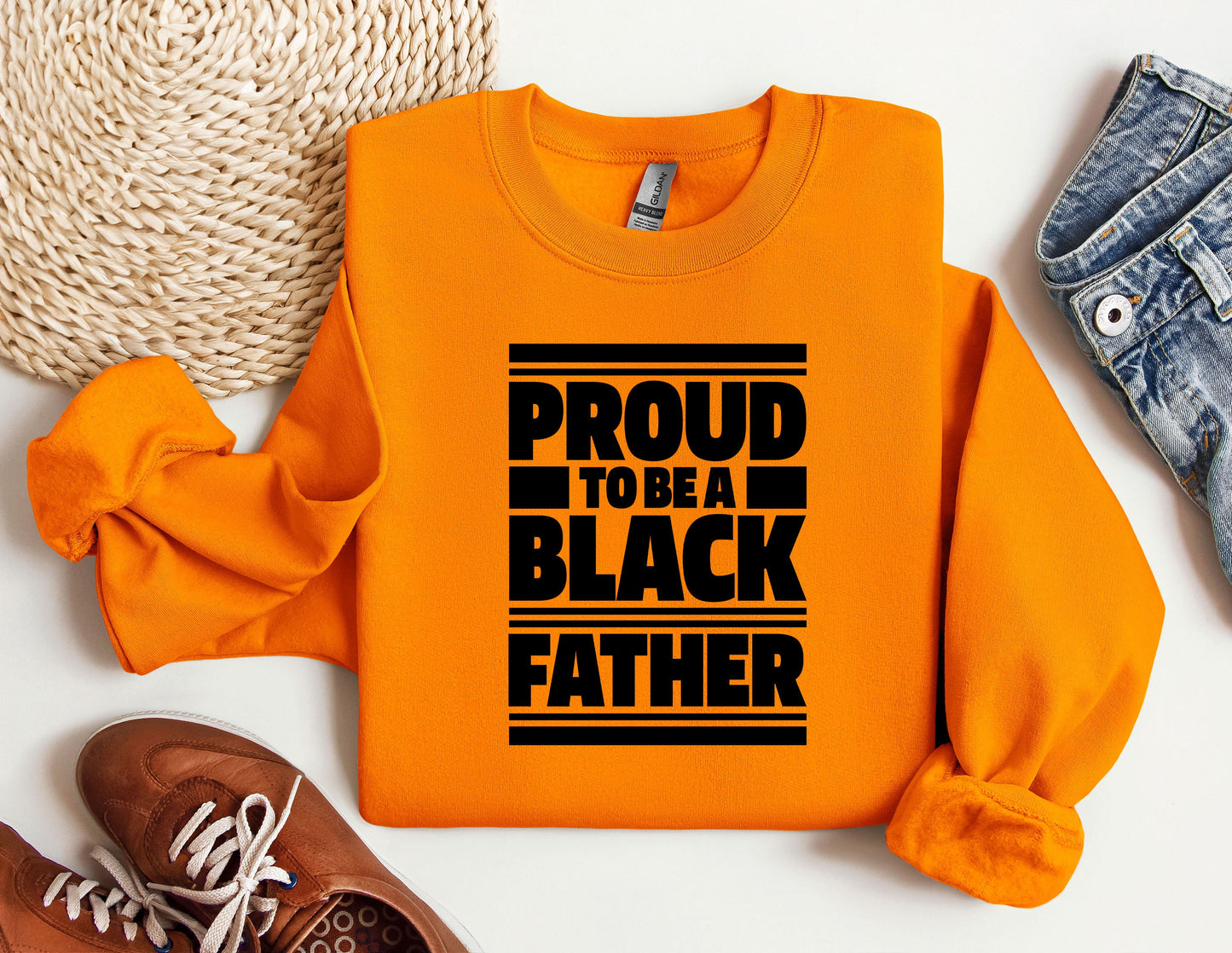 a pair of shoes and a sweatshirt with the words proud to be a black father