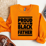 a pair of shoes and a sweatshirt with the words proud to be a black father