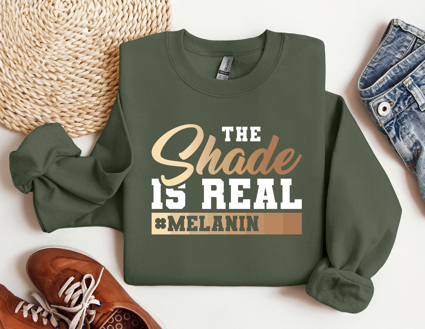 a green sweatshirt with the words the shade is real and melanin on it