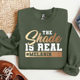 a green sweatshirt with the words the shade is real and melanin on it