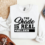 a white sweatshirt with the words the shade is real and melanin on it