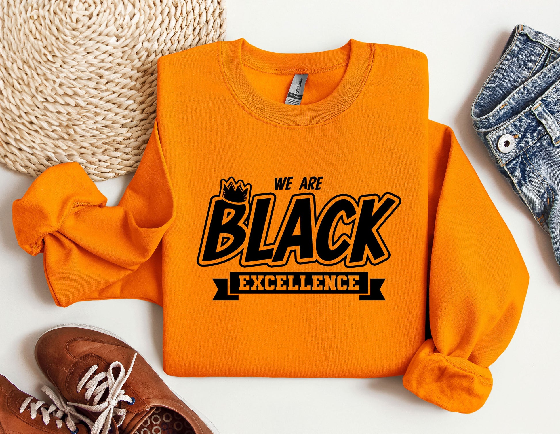 an orange sweatshirt with we are black excellence on it