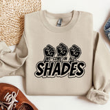 a pair of shoes and a sweatshirt on a table