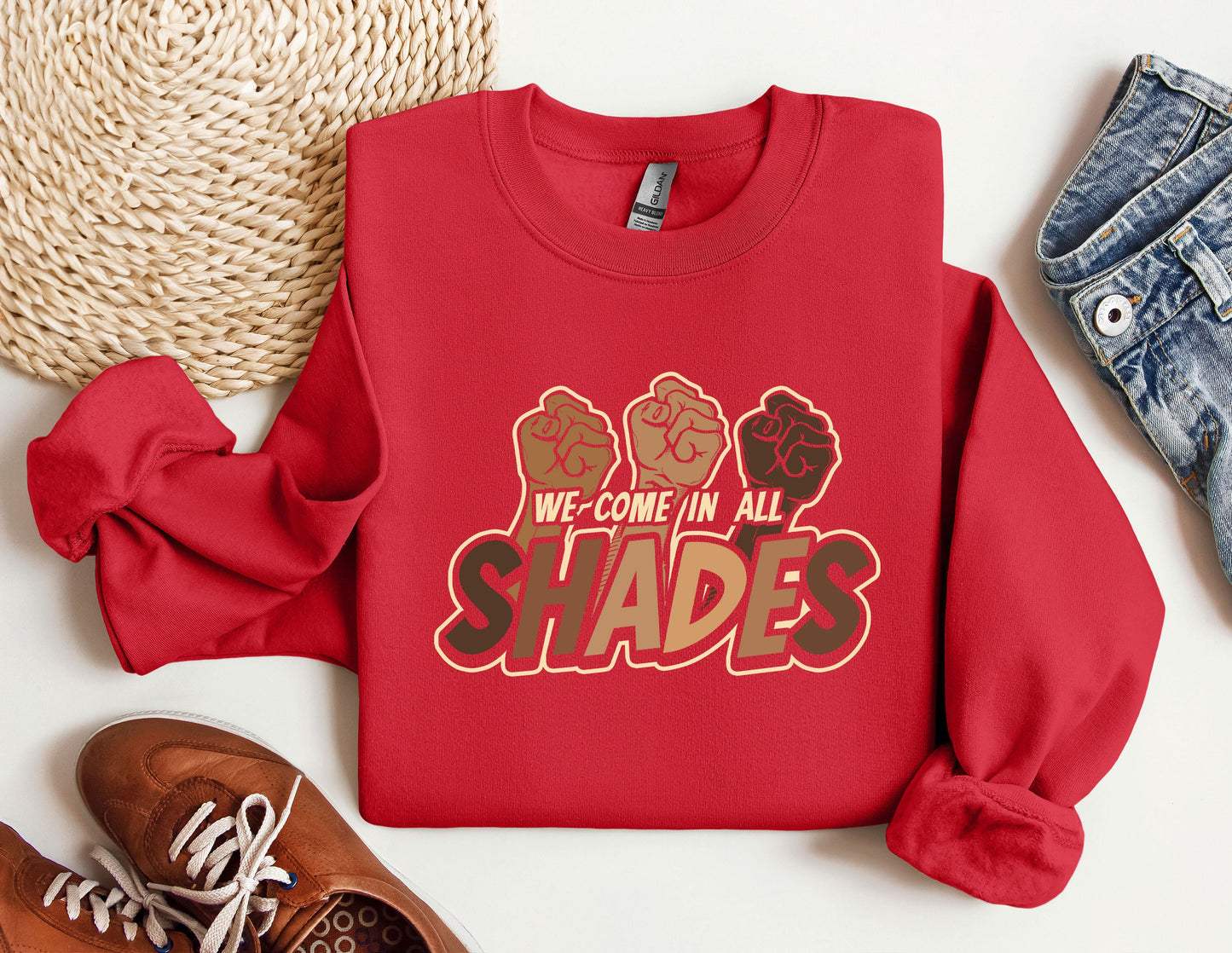 a red sweatshirt that says we come in all shades