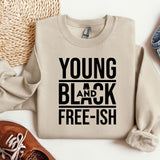 a sweater that says young and black free - ish next to a pair of