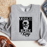 a young black king sweatshirt sitting on top of a table