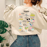 a woman wearing a sweatshirt with a mickey mouse design on it