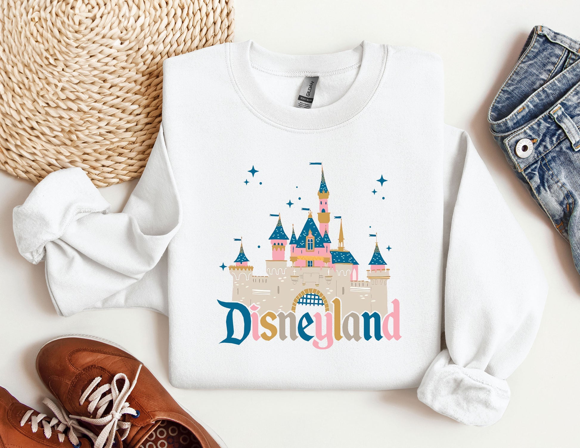 a white shirt with a disneyland castle on it