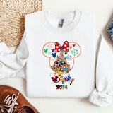 a white shirt with mickey mouse on it