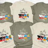 a group of mickey mouse shirts on top of a wooden table