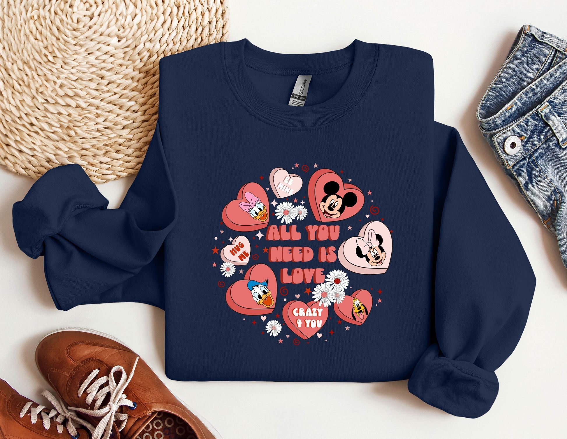 a blue sweatshirt with hearts and mickey mouses on it