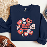 a blue sweatshirt with hearts and mickey mouses on it
