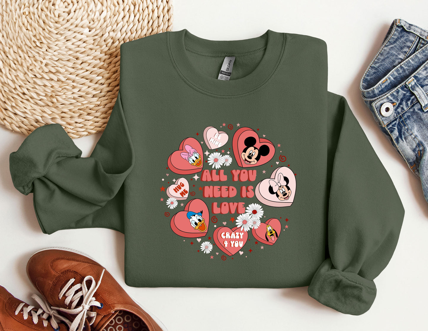 a green sweatshirt with hearts and mickey mouses on it