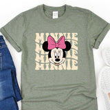 a minnie mouse shirt with a pink bow on it
