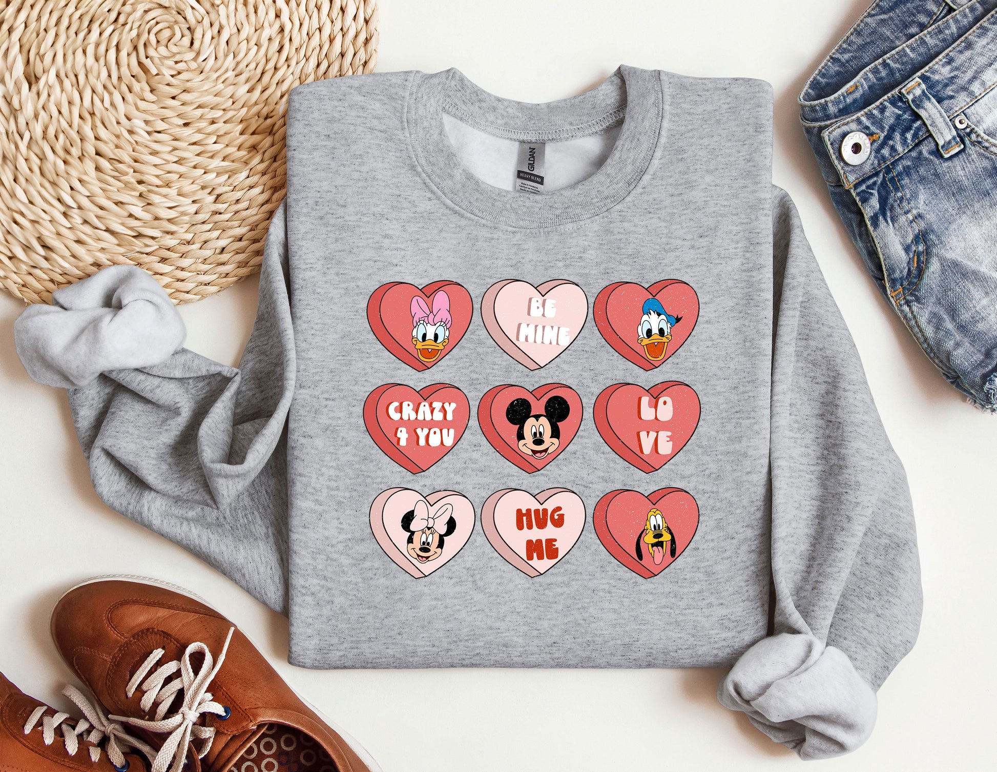 a gray sweatshirt with mickey mouse hearts on it