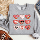 a gray sweatshirt with mickey mouse hearts on it