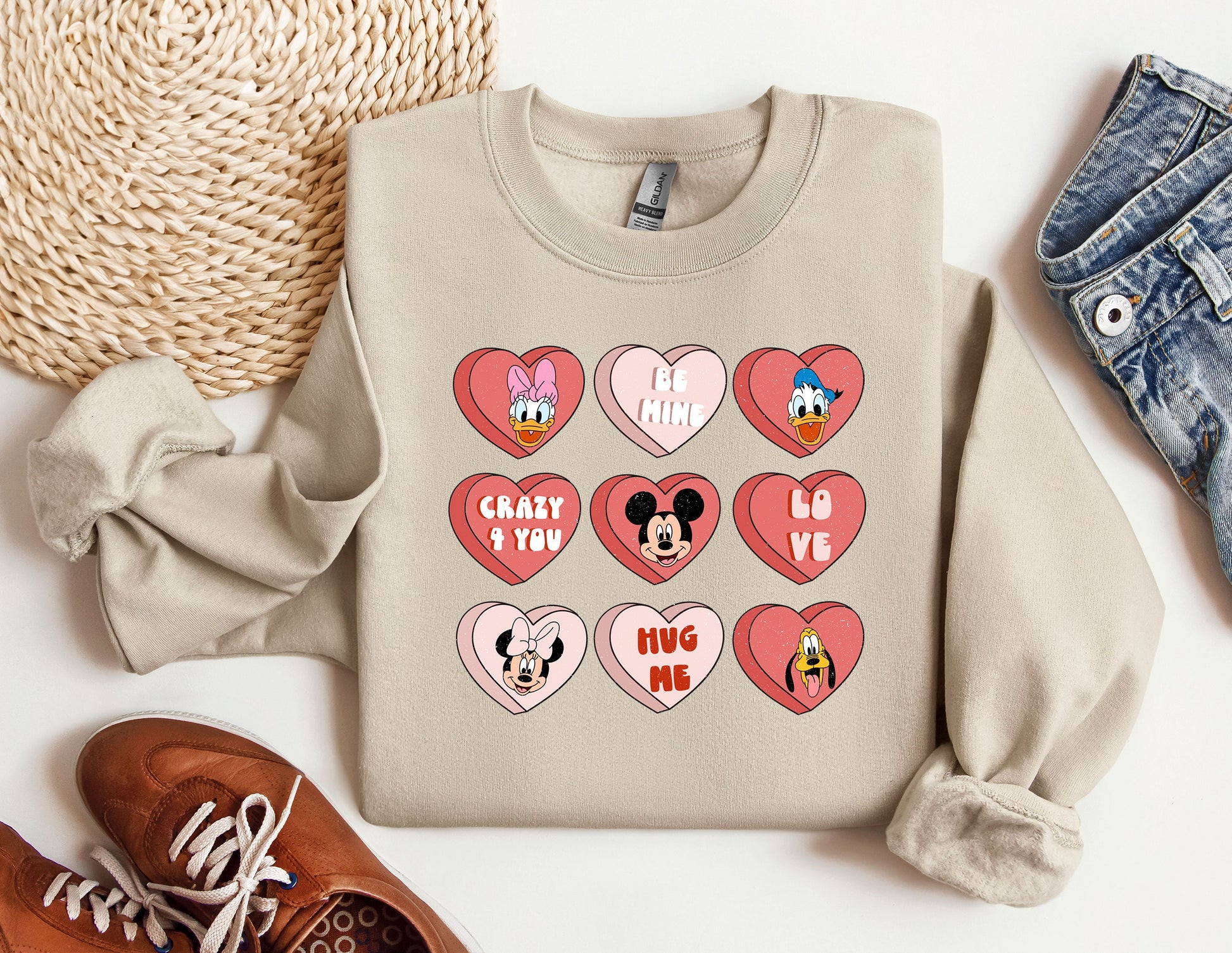 a sweater with hearts and mickey mouse faces on it