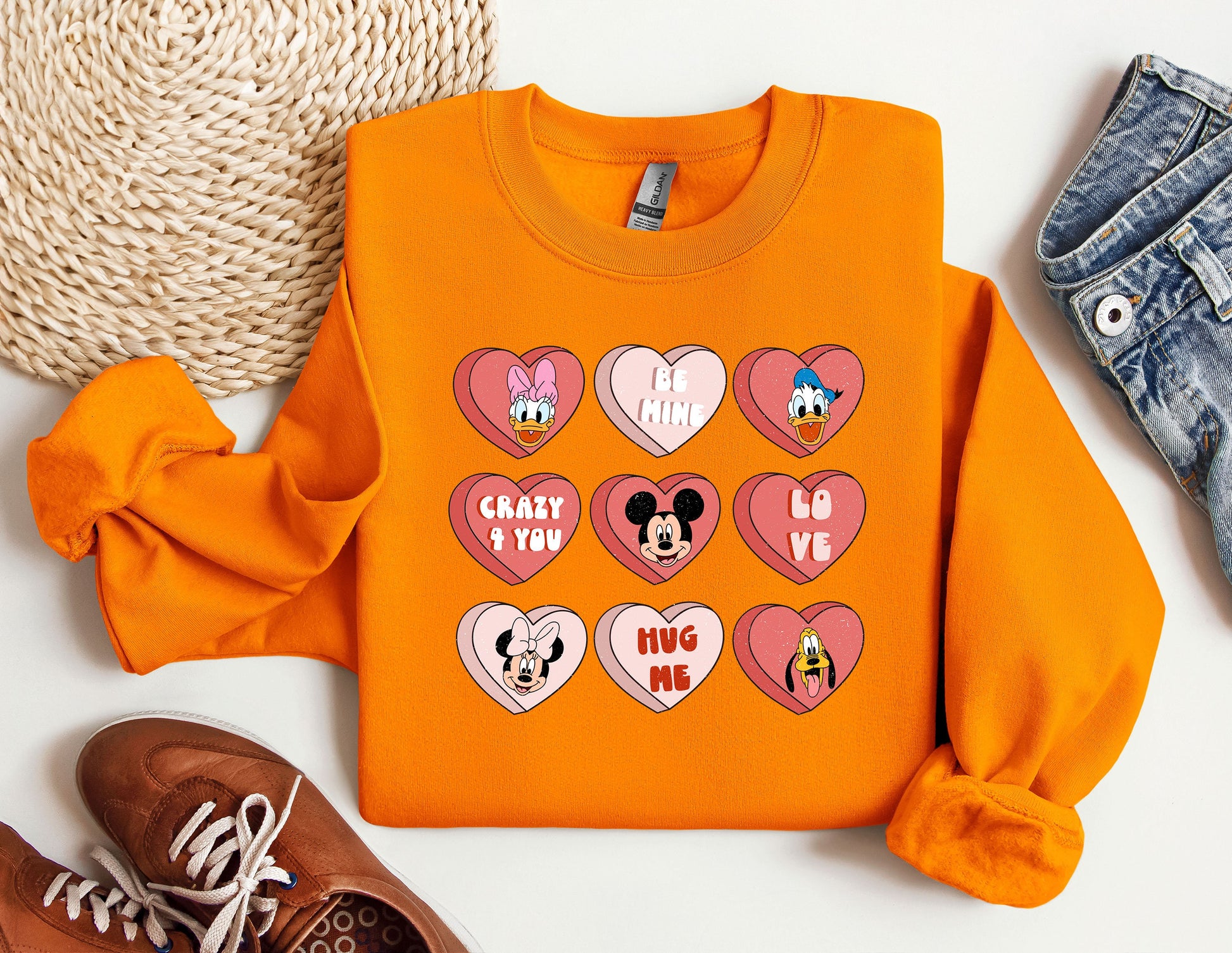 a pair of shoes and a sweatshirt with mickey mouse hearts