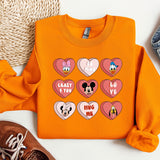 a pair of shoes and a sweatshirt with mickey mouse hearts