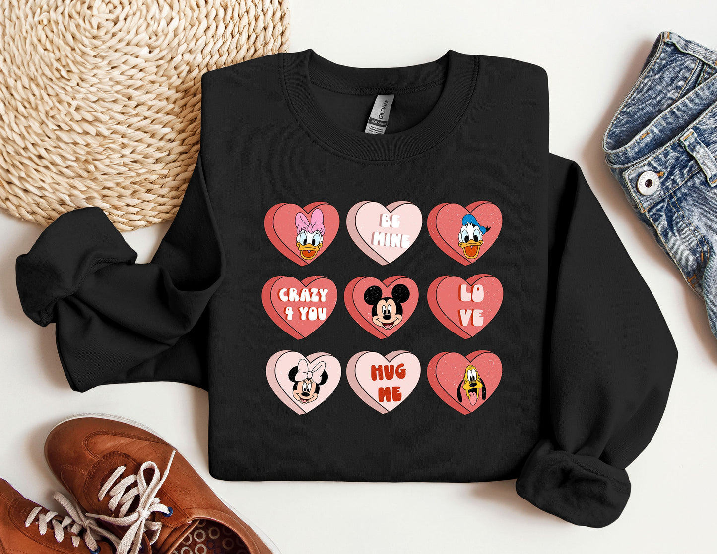 a black shirt with hearts and mickey mouses on it