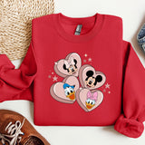 a red sweatshirt with mickey mouse hearts on it